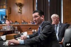 FILE - In this Oct. 5, 2017 file photo, Scott Gottlieb, commissioner of the Food and Drug Administration, answers a question from a Senate committee examining the federal response to the opioid addiction crisis, at the Capitol in Washington.