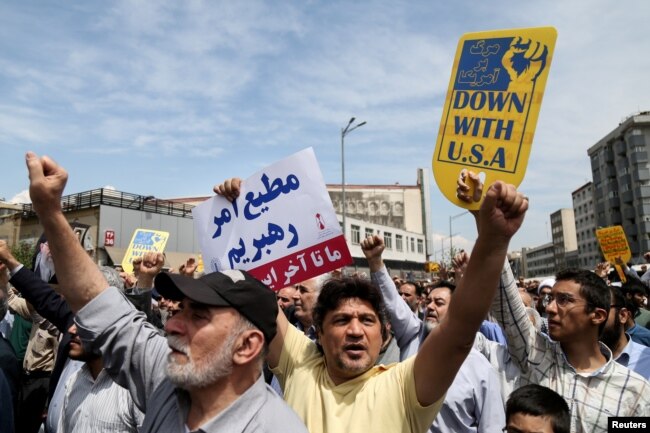 FILE - Iranians shout slogans during a protest against President Donald Trump's decision to walk out of a 2015 nuclear deal, in Tehran, Iran, May 11, 2018.