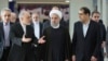 FILE - President Hassan Rouhani (center) listens to head of Iran's Atomic Energy Organization Ali Akbar Salehi (left) while attending a ceremony marking the national day of nuclear technology in Tehran, Iran, Thursday, April 7, 2016. Iran's Health Minister Hassan Ghazizadeh Hashemi is at right.