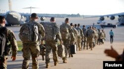 Soldiers of the 602nd Area Medical Support Company walk out to their C-17 transport plane on Pope Army Airfield as they are deployed to St. Thomas in the U.S. Virgin Islands to aid in the aftermath of Hurricane Irma, at Fort Bragg, N.C., Sept. 13, 2017.