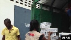Members of the USAID-led Disaster Assistance Response Team (DART) procure and unload urgent Ebola relief supplies and hygiene items in Monrovia, Liberia, on Aug. 27, 2014.