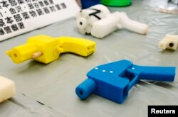 Seized plastic handguns which were created using 3D printing technology are displayed at Kanagawa police station in Yokohama, south of Tokyo, May 8, 2014.