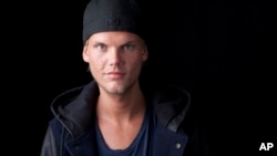 FILE - Swedish DJ, remixer and record producer Avicii poses for a portrait, in New York. 