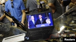 Gun customers watch video Obama gun control announcement, Bullet Hole gun shop, Sarasota, Florida, Jan. 16, 2013.