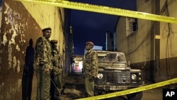 Kenyan police guard the scene of a suspected grenade blast at a pub in downtown Nairobi, Kenya, October 24, 2011.