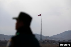 FILE - A North Korean flag flutters on top of a tower at the propaganda village of Gijungdong in North Korea, in this picture taken near the truce village of Panmunjom.