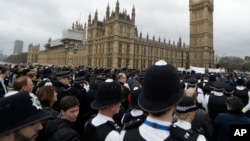 Police officers take part in a commemorative event to mark last week's attack outside Parliament that killed four people on Westminster Bridge in London, March 29, 2017.