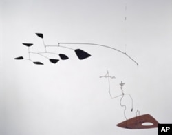 Alexander Calder's mobile of a wire figure of Saul Steinberg with clouds following behind.