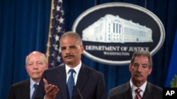 IRS Commissioner John Koskinen, left, and Deputy Attorney General James Cole, right, watch as Attorney General Eric Holder speaks during a news conference at the Justice Department, on Monday, May 19, 2014, in Washington