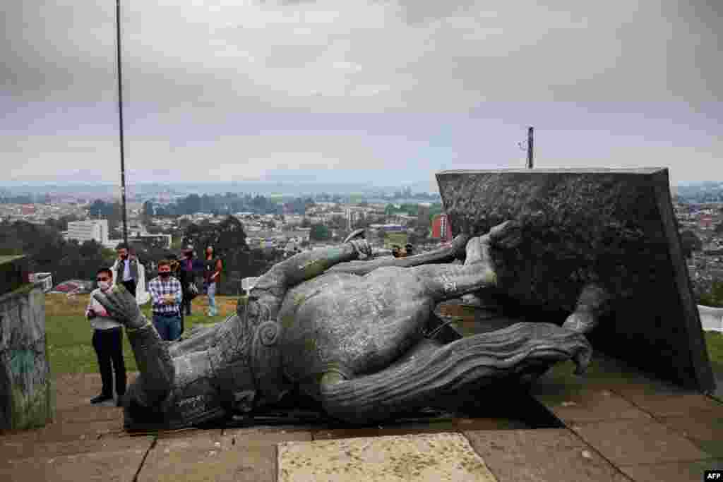 The statue of Sebastian de Belalcazar, a 16th century Spanish conqueror, lies on the ground after it was pulled down by indigenous people in Popayan, Cauca department, Colombia, Sept. 16, 2020.