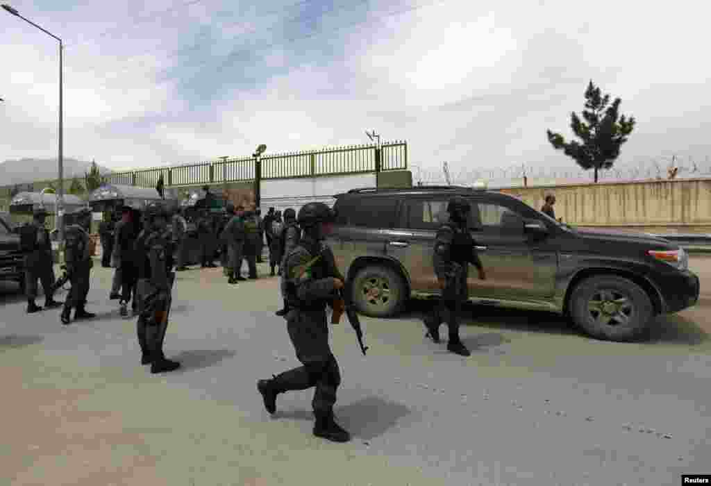 Afghan police secure the area outside Cure Hospital after three Americans were killed, Kabul, April 24, 2014.