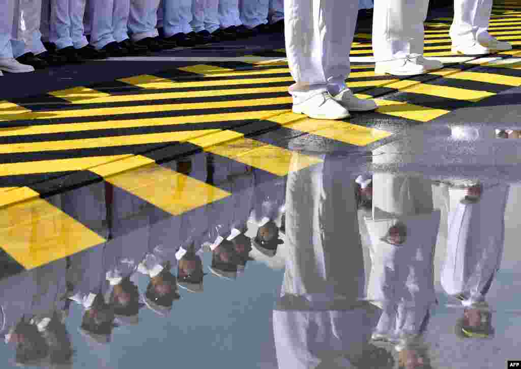 Egyptian soldiers stand on the deck of the BPC Anwar el-Sadat military cruise ship during a flag ceremony in Saint-Nazaire, western France.