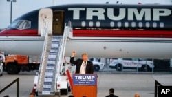 FILE - Republican presidential candidate Donald Trump holds a plane-side rally in Vienna, Ohio, Monday, March 14, 2016. The previously self-funded candidate will start asking for contributions to finance his campaign.