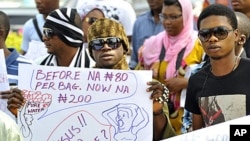 A protester carries a placard during a rally against fuel subsidy cuts in Nigeria's capital, Abuja, January 6, 2012.