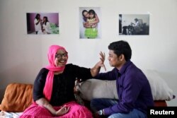 Pramodini Roul, 24, an acid attack survivor and a campaigner at Chhanv, an NGO that supports acid attack victims, and her partner Saroj Sahoo, 26, a manager at Chhanv, share a moment at the "Sheroes" home for acid attack victims in Noida, India, Feb. 8, 2018.