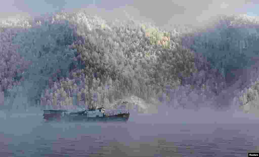 A motor boat sails along the Yenisei River, with the air temperature at about minus 20&deg; C (- 4&deg;F), outside the Siberian city of Krasnoyarsk, Russia.