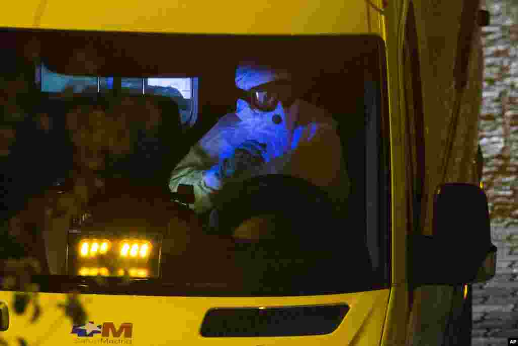 An ambulance transporting a Spanish nurse believed to have contracted the Ebola virus from a 69-year-old Spanish priest, leaves Alcorcon Hospital in Madrid, Spain, Oct. 7, 2014. 