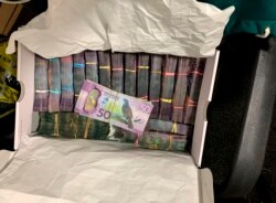 In this undated photo supplied by the New Zealand police, a box containing a large amounts of cash is seen after being discovered during a police raid as part of Operation Trojan. Authorities in Australia and New Zealand Tuesday, June 8, 2021