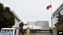 The flag of North Korea flies at half-staff at the North Korean Embassy in Bucharest, Romania, December 19, 2011.