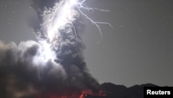 Volcanic lightning over Mount Sakurajima is pictured from Tarumizu city, Kagoshima prefecture, Japan, Dec. 17, 2020.