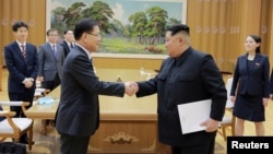FILE - North Korean leader Kim Jong Un shakes hands with Chung Eui-yong, who led a special delegation of South Korea's president, in this photo released by North Korea's Korean Central News Agency, March 6, 2018.