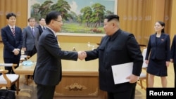 FILE - North Korean leader Kim Jong Un shakes hands with Chung Eui-yong, who led a special delegation of South Korea's president, in this photo released by North Korea's Korean Central News Agency, March 6, 2018.