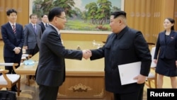 FILE - North Korean leader Kim Jong Un shakes hands with Chung Eui-yong, who led a special delegation of South Korea's president, in this photo released by North Korea's Korean Central News Agency, March 6, 2018.