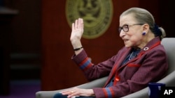FILE - Supreme Court Justice Ruth Bader Ginsburg waves goodbye to those who came to listen and participate in her "fireside chat" in the Bruce M. Selya Appellate Courtroom at the Roger William University Law School in Bristol, Rhode Island, Jan. 30, 2018.