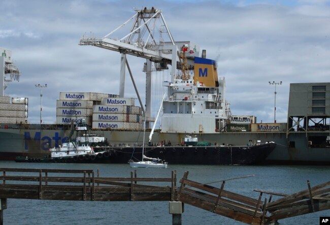 A container ship is unloaded at the Port of Oakland in Oakland, Calif., May 16, 2018.