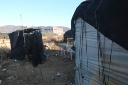 FILE An outdoor toilet, left, is placed beside a dormitory for migrant workers at a farm in Pocheon, South Korea on Feb. 8, 2021. Workers often are crammed in shipping containers or flimsy, poorly ventilated huts. (AP Photo/Ahn Young-joon)