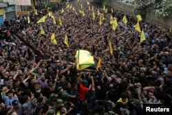 Hezbollah members carry the coffin of top Hezbollah commander Mustafa Badreddine, who was killed in an attack in Syria, during his funeral in Beirut's southern suburbs, Lebanon, May 13, 2016.