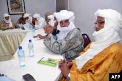 FILE - Ethnic Tuareg and Arab militias from Mali meet on Aug. 28, 2014 in Ouagadougou, Burkina Faso, to talk about a homeland in northern Mali (called Azawad) they lay claim on, ahead of peace negotiations with the government.