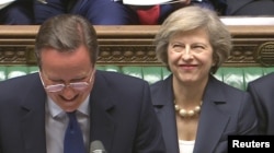 Britain's outgoing Prime Minister, David Cameron (C), incoming prime minister Theresa May (R) and Chancellor of the Exchequer George Osborne, laugh during Prime Minister's Questions in the House of Commons, in central London, Britain on July 13, 2016.