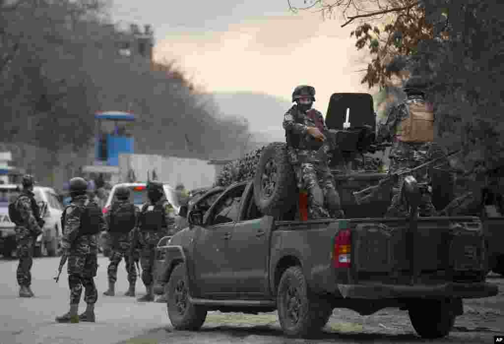 Intelligence agency commandos arrive after suicide bombers armed with assault rifles and hand grenades attacked a guesthouse used by foreigners in Kabul, March 28, 2014.