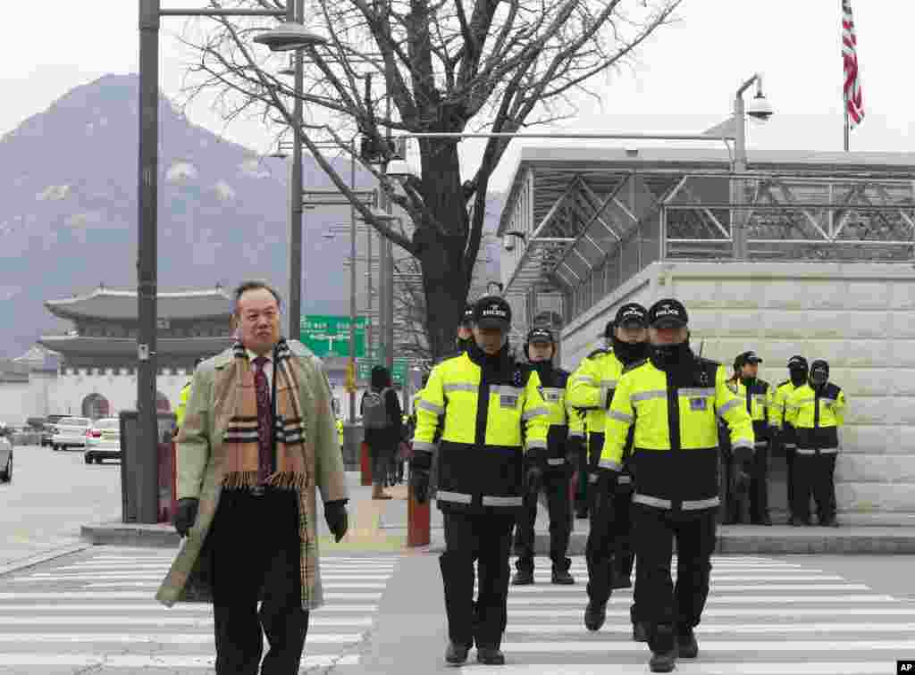 South Korean police officers patrol near the U.S. Embassy in Seoul, South Korea, March 5, 2015.