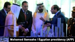 Egyptian President Abdel-Fattah el-Sissi, right, and Prime Minister of the United Arab Emirates (UAE) and Sheikh Mohammed bin Rashid al-Maktoum, center, look at a model of the new Egyptian capital Cairo displayed at the Egypt Economic Conference, March 14, 2015.