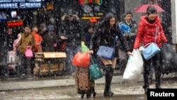 2016年1月31日湖北武汉携带行李离开火车站的旅客
