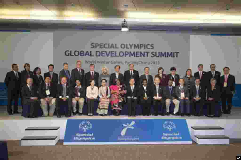 Summit participants pose for a group photo on stage after the Special Olympics Global Development Summit including the Chairman and CEO of Special Olympics, Timothy Shriver, front, second from right, Organizing Committee Chairwoman Na Kyung-Won, Myanmar Pro-democracy politician Aung San Suu Kyi, Malawi&#39;s President Joyce Banda, and the retired athlete Loretta Claiborne in PyeongChang, South Korea on Wednesday, Jan. 30, 2013.&nbsp;