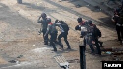 ရန်ကုန်မြို့မှာ စစ်အာဏာသိမ်းမှု ဆန့်ကျင်ဆန္ဒပြသူတွေကို ဖမ်းဆီးနေတဲ့ ရဲတပ်ဖွဲ့ဝင်များ။ (မတ် ၂၊ ၂၀၂၁)