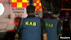 FILE - Members of Bangladesh's notorious Rapid Action Battalion (RAB) are seen deployed in Dhaka, Bangladesh, July 2, 2016. A Bangladeshi man featured in a recent foreign-produced documentary has accused the RAB of torturing people in custody. He has now been arrested.