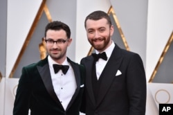 Sam Smith, right, and Jimmy Napes arrive at the Oscars on Feb. 28, 2016, at the Dolby Theatre in Los Angeles.