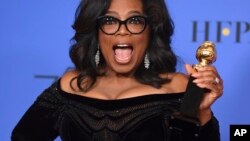 Oprah Winfrey poses in the press room with the Cecil B. DeMille Award at the 75th annual Golden Globe Awards Jan. 7, 2018, in Beverly Hills, Calif. 