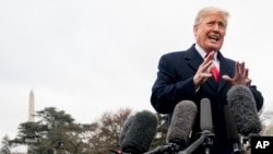 President Donald Trump speaks to members of the media before boarding Marine One on the South Lawn of the White House in Washington, Nov. 26, 2018, for a short trip to Andrews Air Force Base, Maryland, and then on to Mississippi for rallies.