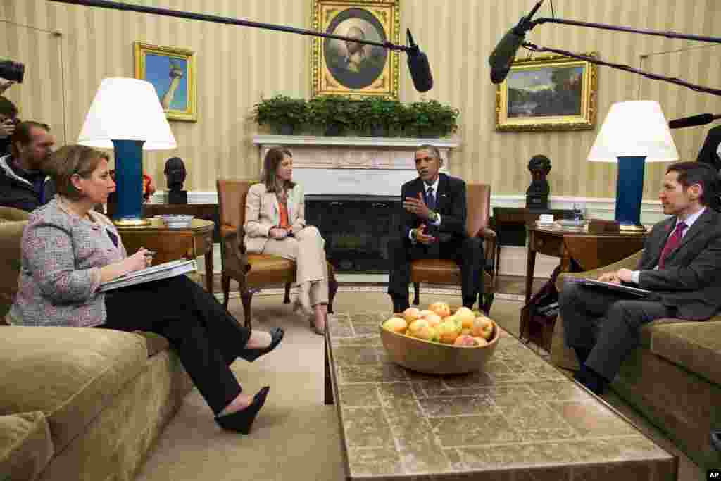 President Barack Obama speaks to the media about the government’s Ebola response, in the Oval Office of the White House in Washington, D.C., Oct. 16, 2014.