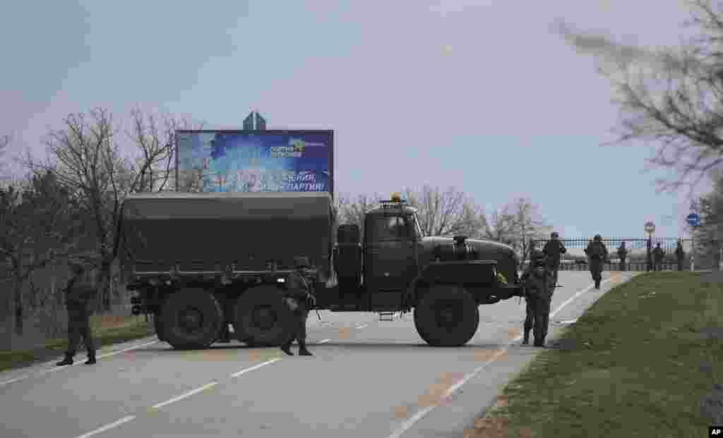Russian troops block the road way towards the military airport at the Black Sea port of Sevastopol in Crimea, Feb. 28, 2014. 