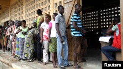 Voters are seen lining up to cast their ballots in Lome, Togo, July 25, 2013. 