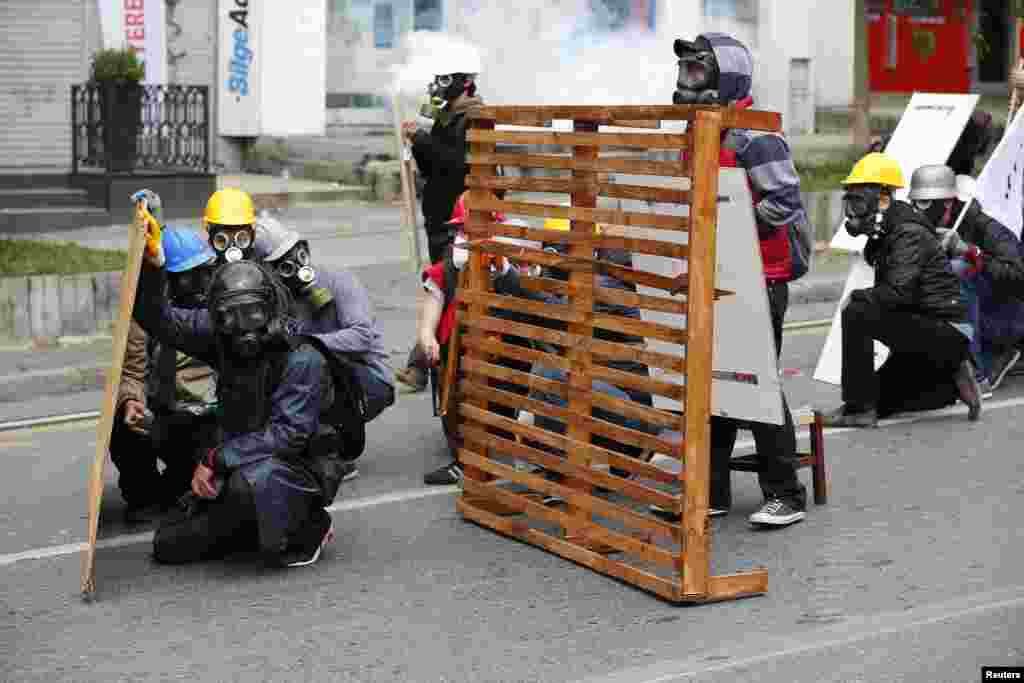 Protester shield themselves from police during a May Day demonstration in Istanbul, Turkey.