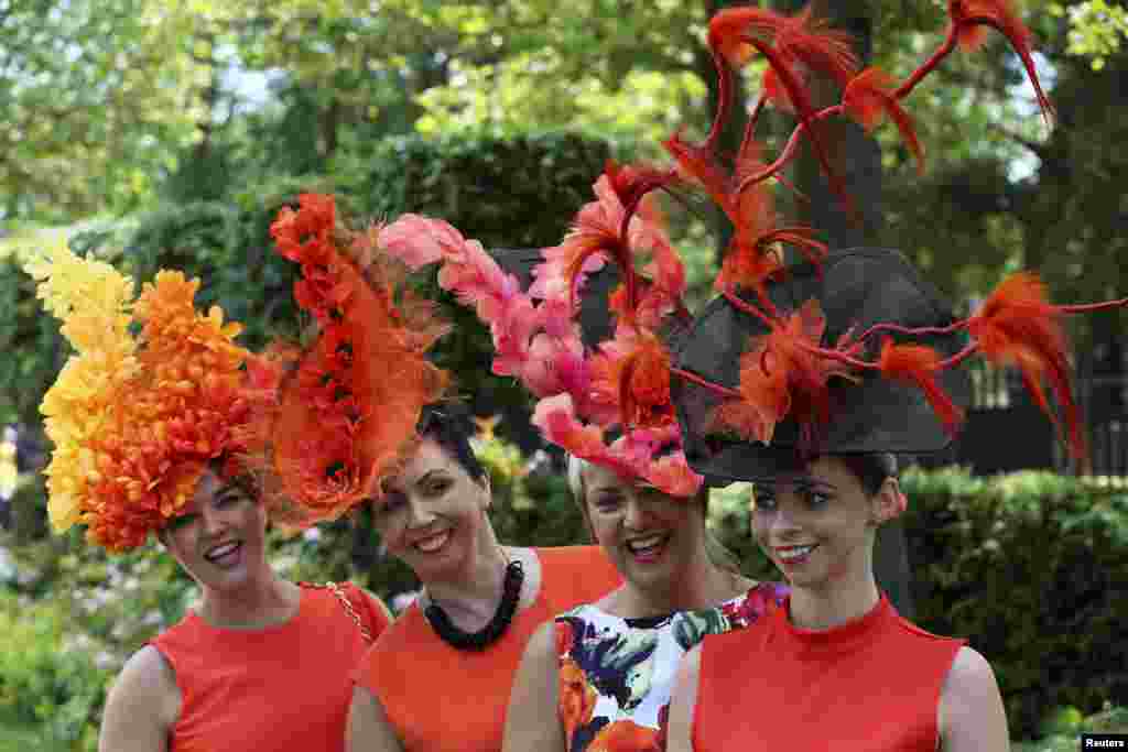 A group of racegoers poses for photographers on the first day of the Royal Ascot horse racing festival at Ascot, southern England.