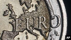The map of Europe is featured on the face of a two Euro coin seen in this photo illustration taken in Rome, (December 2011 file photo)