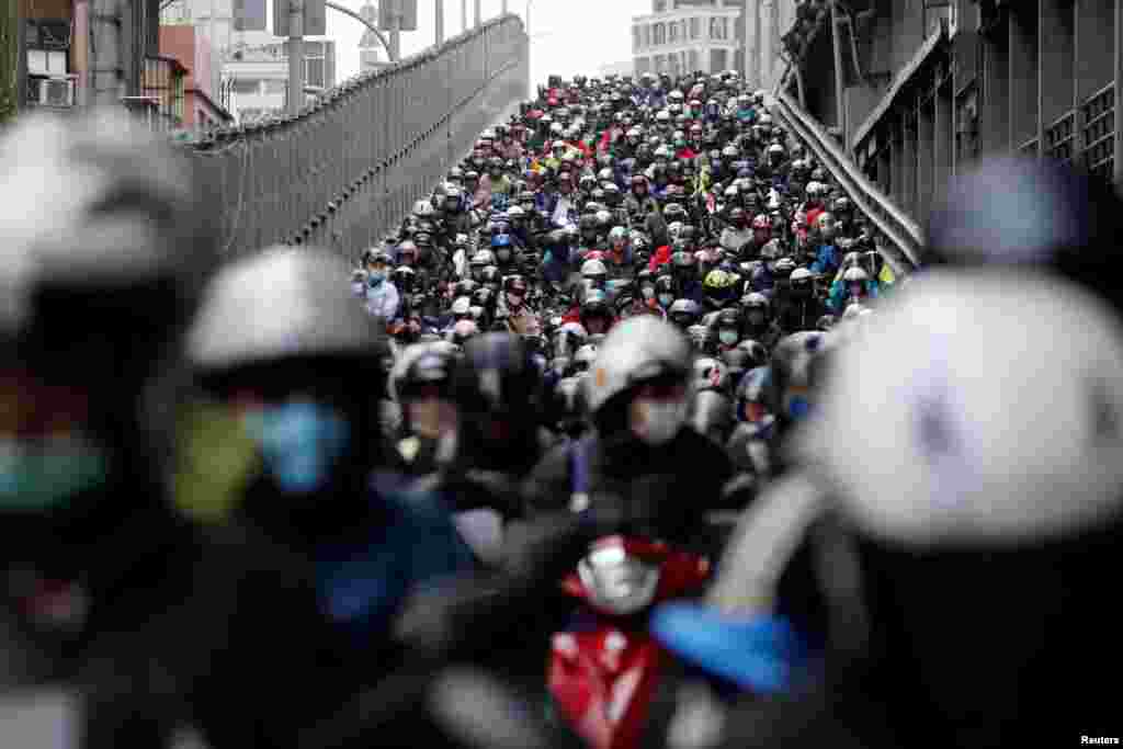 People wear face masks to protect themselves from the coronavirus disease (COVID-19) spread during the morning rush hour in Taipei, Taiwan.